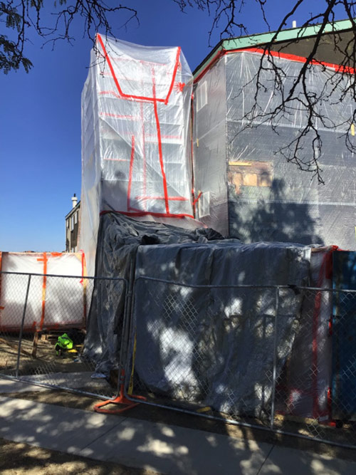 Exterior containment setup for asbestos abatement at a commercial property in Thornton, Colorado by Peak Environmental