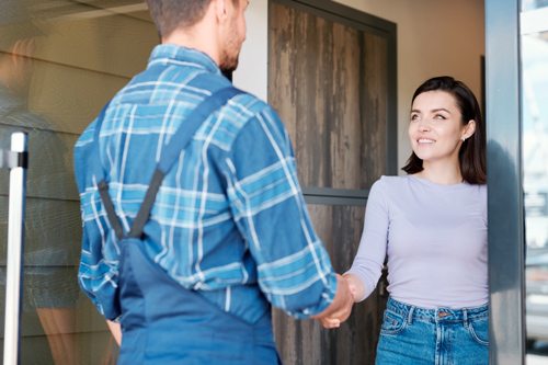 Environmental specialist greeting client at home for demolition and emergency response services